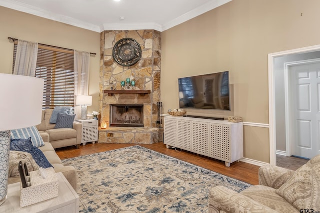 living room featuring crown molding, a fireplace, and hardwood / wood-style flooring