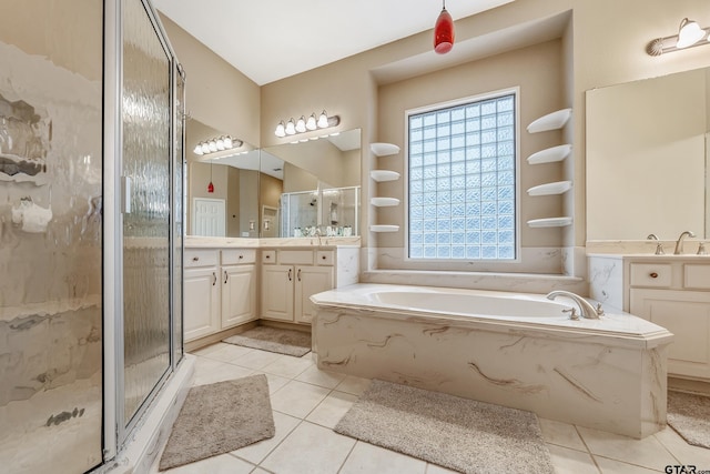 bathroom with tile patterned floors, shower with separate bathtub, and vanity