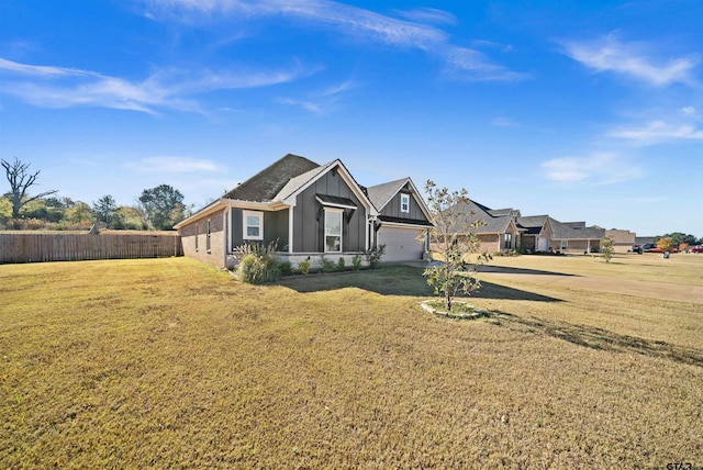 view of front of home featuring a front lawn and a garage