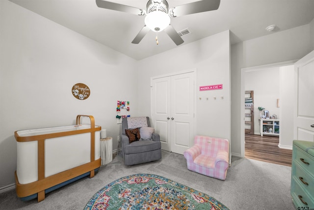 bedroom with hardwood / wood-style floors, ceiling fan, and a closet