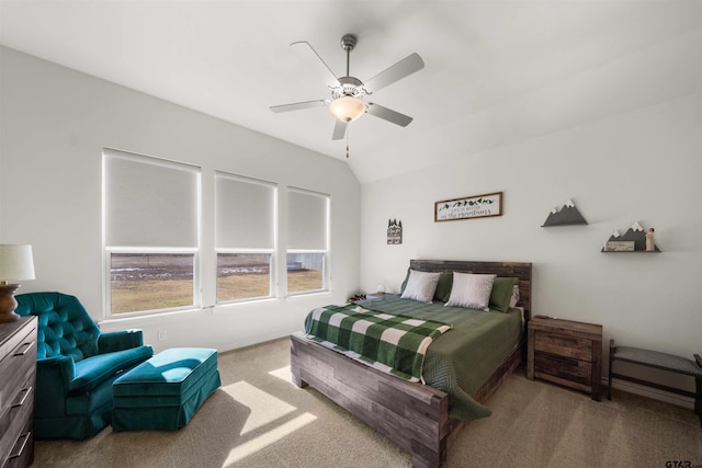 carpeted bedroom with vaulted ceiling and ceiling fan