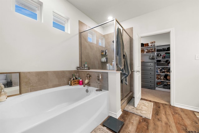 bathroom featuring hardwood / wood-style flooring and independent shower and bath