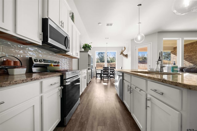 kitchen featuring decorative backsplash, dark hardwood / wood-style flooring, stainless steel appliances, decorative light fixtures, and white cabinets