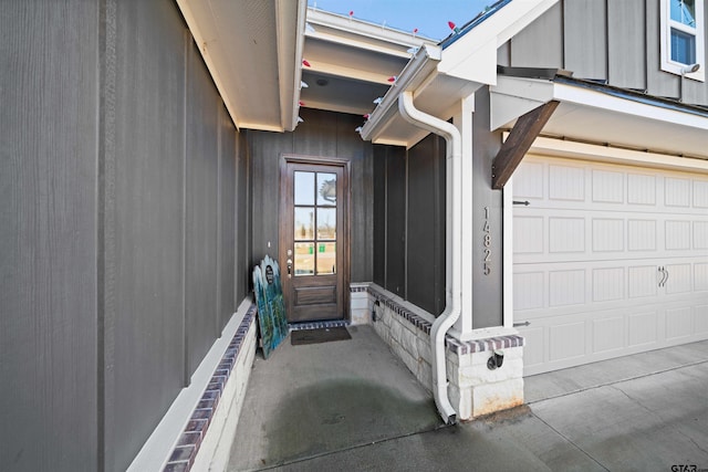 view of exterior entry with a garage