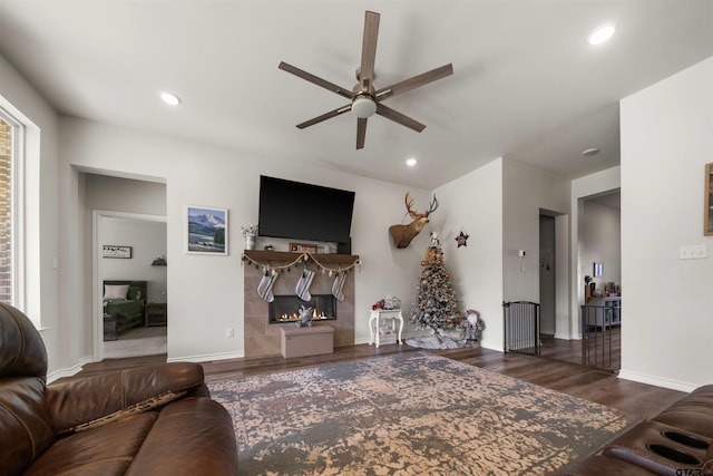 living room featuring dark hardwood / wood-style flooring and ceiling fan