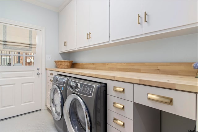 washroom with cabinets, independent washer and dryer, and ornamental molding