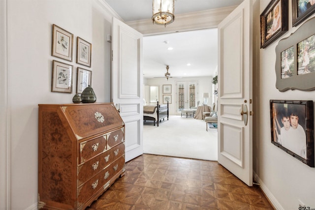 corridor with decorative columns, dark parquet flooring, and ornamental molding