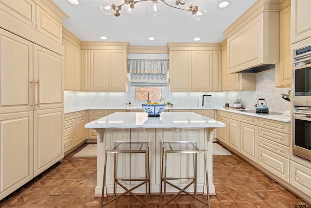 kitchen featuring a kitchen bar, parquet flooring, and a center island