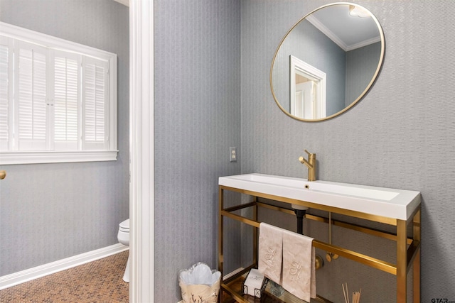 bathroom featuring toilet and crown molding