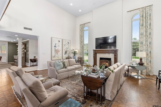 living room with a towering ceiling and dark parquet flooring