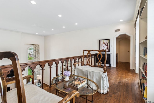 hall featuring dark wood-type flooring and ornamental molding