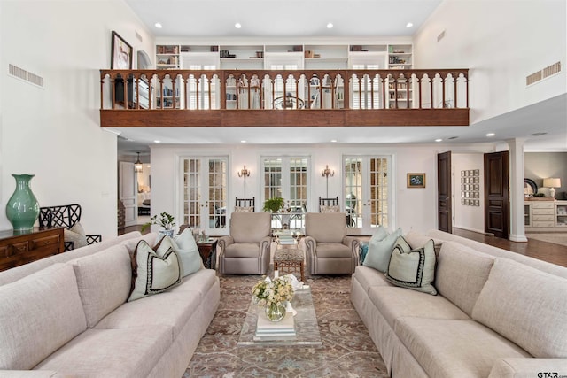 living room with a high ceiling and french doors