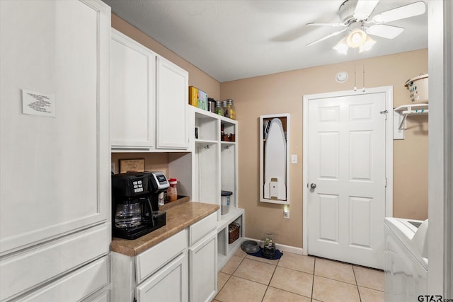 mudroom featuring a ceiling fan, baseboards, and light tile patterned flooring