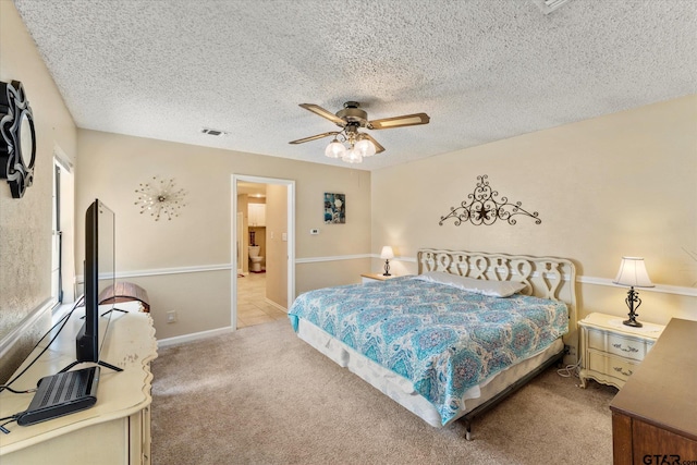 bedroom featuring ceiling fan, light carpet, a textured ceiling, and visible vents