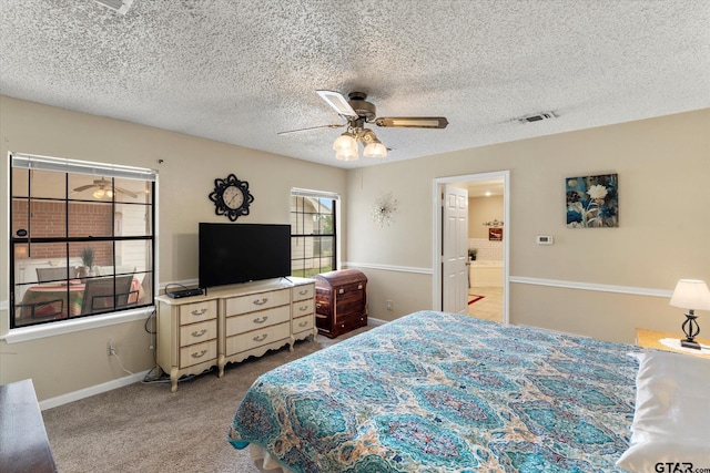bedroom featuring a textured ceiling, visible vents, ceiling fan, carpet flooring, and baseboards