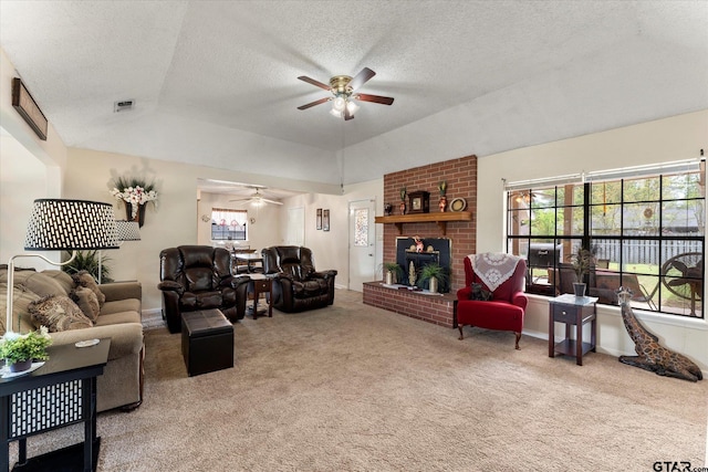carpeted living area featuring a textured ceiling, plenty of natural light, lofted ceiling, and ceiling fan