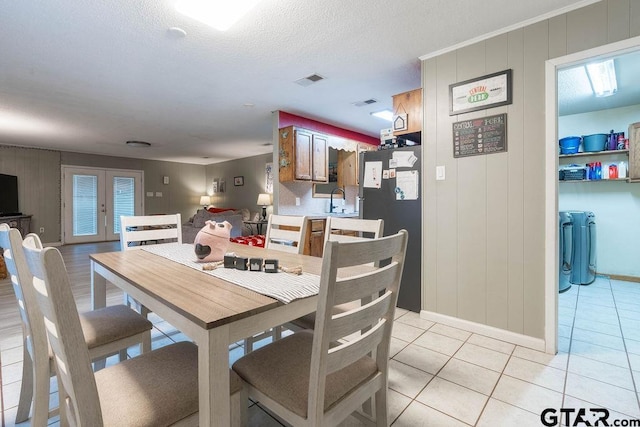 dining area with baseboards, french doors, light tile patterned flooring, and visible vents