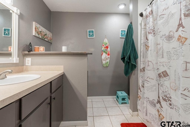 full bath featuring tile patterned floors, curtained shower, baseboards, and vanity