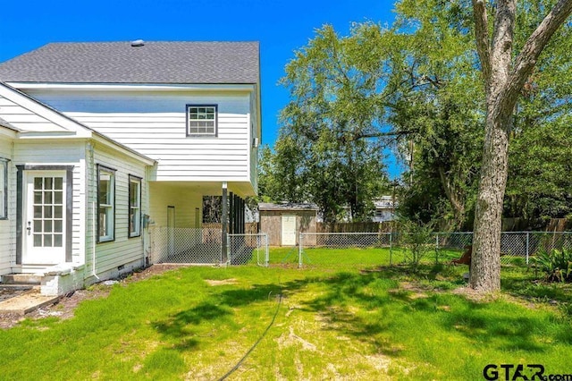 rear view of house featuring a lawn