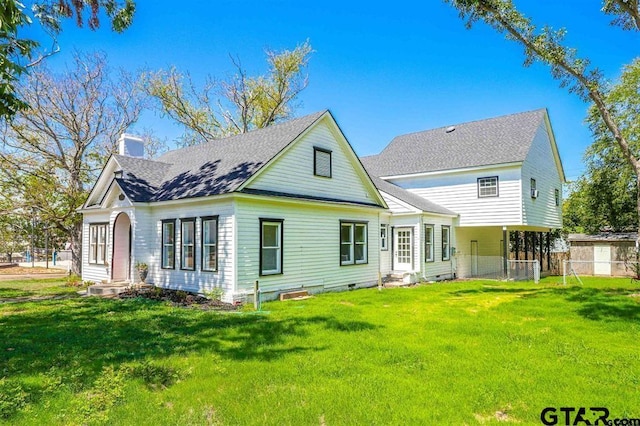 rear view of house with a yard