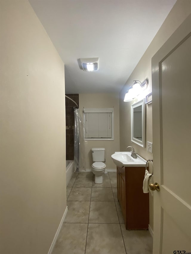 bathroom with shower / bath combination with curtain, toilet, vanity, baseboards, and tile patterned floors