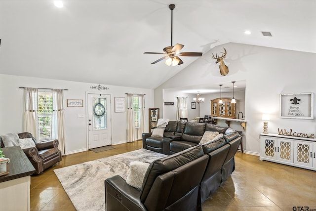 tiled living room featuring ceiling fan with notable chandelier and high vaulted ceiling