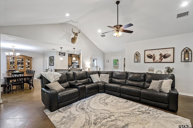 tiled living room featuring ceiling fan with notable chandelier and high vaulted ceiling