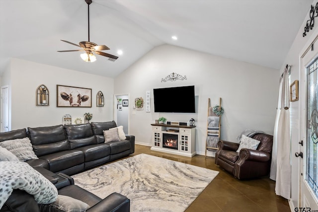 living room featuring dark tile patterned floors, vaulted ceiling, ceiling fan, and a fireplace