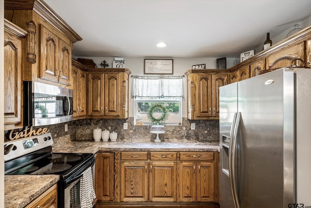 kitchen featuring appliances with stainless steel finishes and decorative backsplash