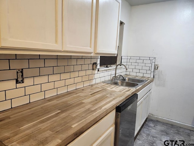 kitchen with tasteful backsplash, wood counters, dishwasher, and sink