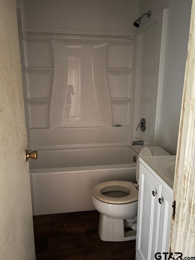 full bathroom with hardwood / wood-style floors, vanity, shower / bath combination, and toilet