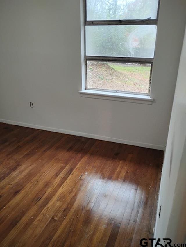 empty room with dark wood-type flooring