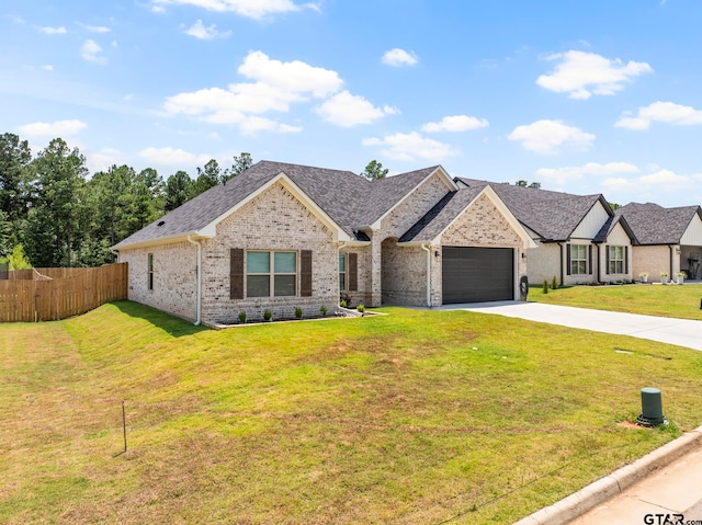 view of front of house featuring a front lawn and a garage