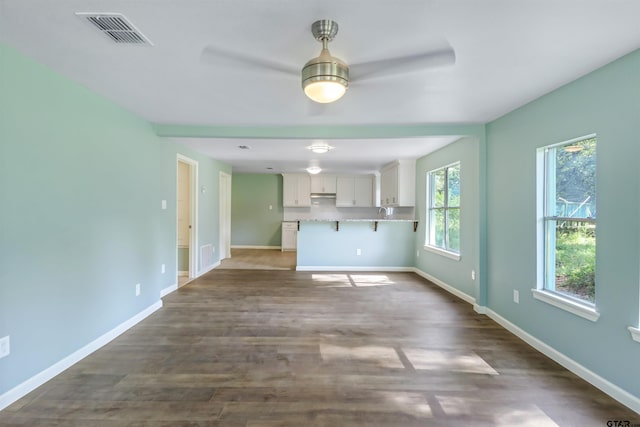 unfurnished living room featuring dark hardwood / wood-style floors