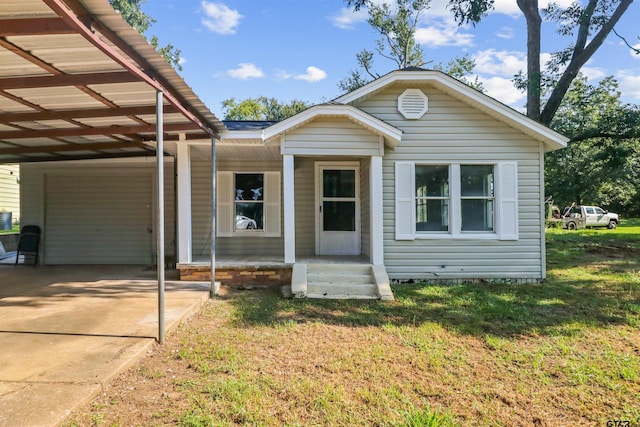 view of front of property with a front lawn and a carport