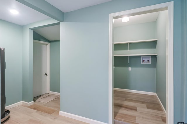 clothes washing area featuring washer hookup and light wood-type flooring