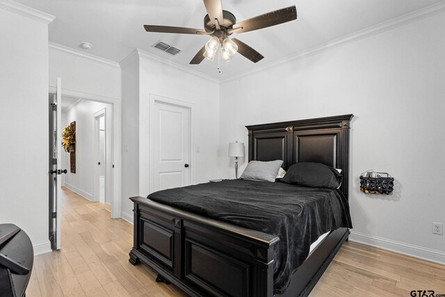 bedroom featuring ceiling fan, ornamental molding, and light wood-type flooring