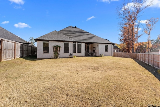 back of house with a lawn