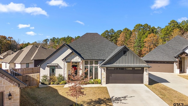 view of front of house with a front yard and a garage