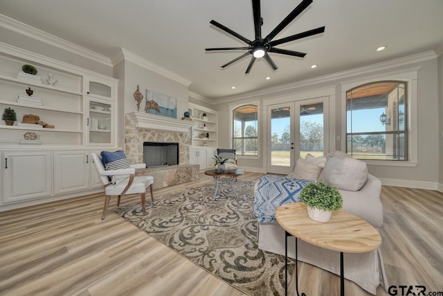 living room featuring ceiling fan, french doors, light hardwood / wood-style floors, and ornamental molding