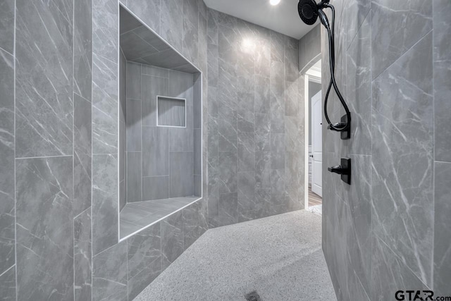 bathroom with tile walls and tiled shower