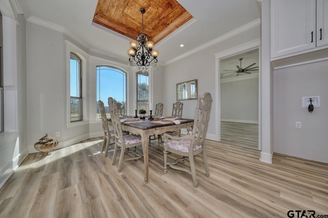 dining space with light wood-type flooring and crown molding