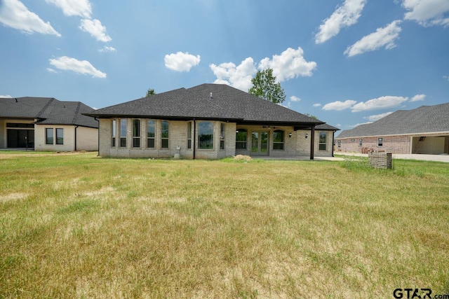 rear view of property featuring a yard