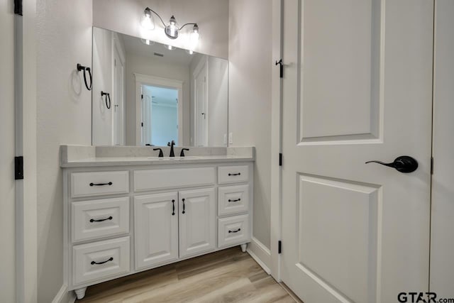 bathroom featuring hardwood / wood-style floors and vanity