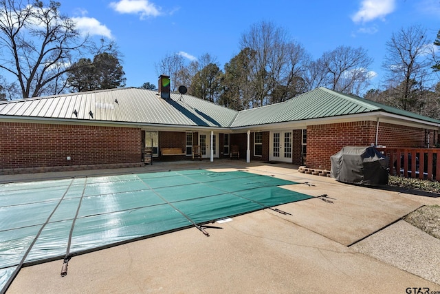 view of swimming pool featuring a patio, area for grilling, and french doors