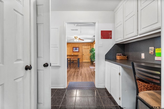 interior space featuring white cabinetry, decorative backsplash, and ceiling fan