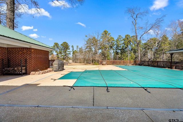 view of swimming pool with a patio