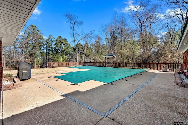 view of swimming pool with a patio