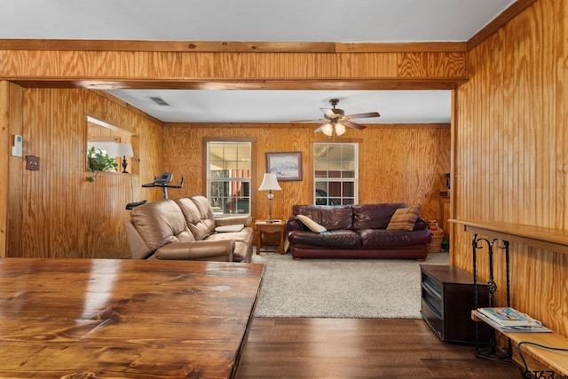 living room featuring wooden walls, dark hardwood / wood-style floors, and ceiling fan