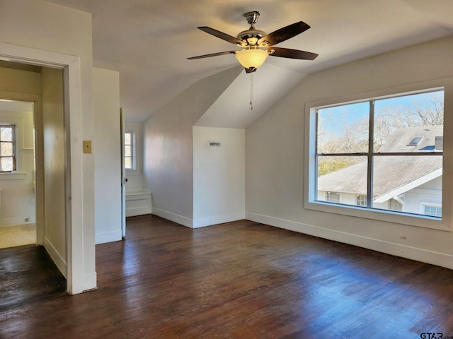 bonus room featuring dark wood-type flooring, lofted ceiling, and ceiling fan